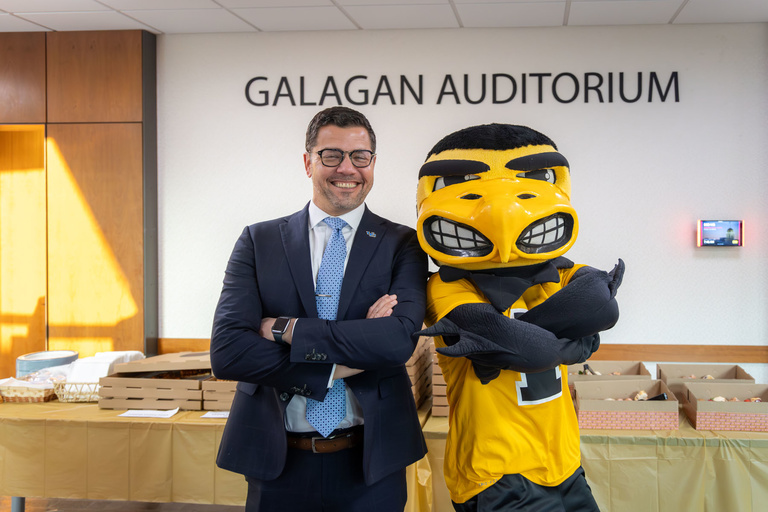 Herky poses for a photo with keynote speaker Dr. Marcelo Araujo.